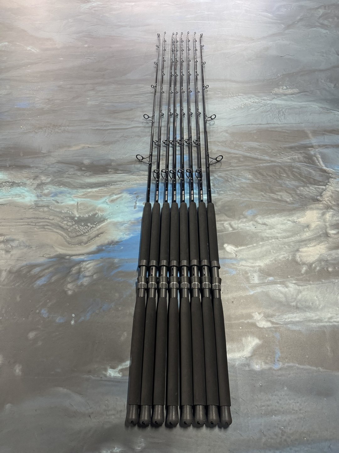 An all-black matched set fanned tip to butt across the marbled bench